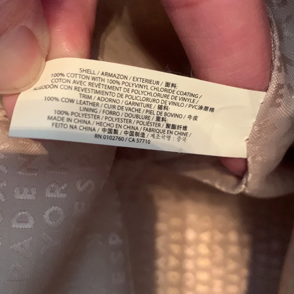 Kate Spade cream colored cloth tote with green leaf pattern.